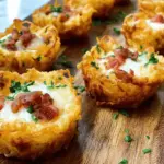 Delicious tater tot appetizer cups filled with cheese and bacon, perfect for party snacks.