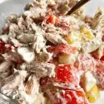 Colorful Italian Grinder Chicken Salad with grilled chicken, fresh vegetables, and herbs in a bowl.