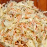 Super creamy coleslaw salad with fresh vegetables and herbs, perfect side dish for summer BBQs.